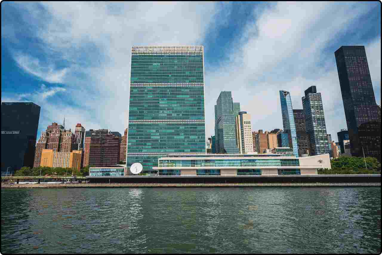 Hudson River view of the United Nations headquarters, with nearby buildings and reflections on the water